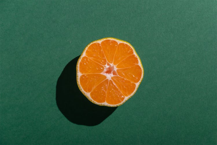 bisected orange on green surface