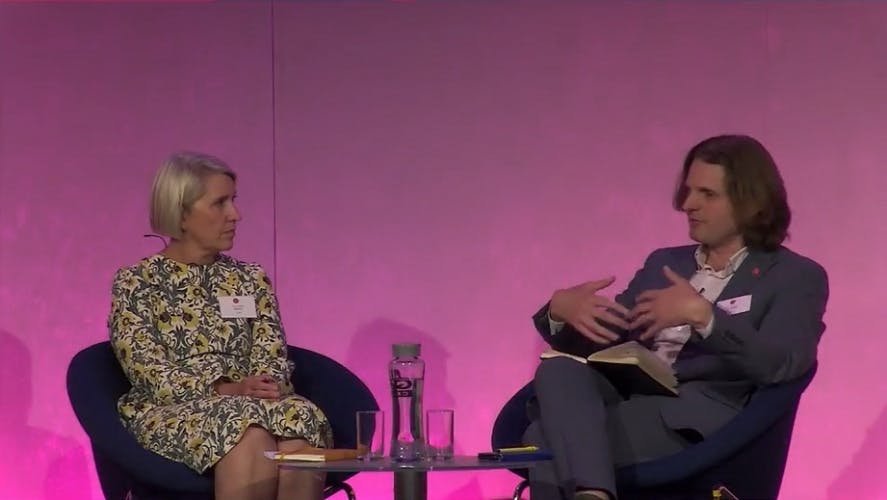 Specsavers' Tina Christison and Econsultancy's Steffan Aquarone sit on-stage at Econsultancy Live: CX 2022.